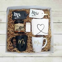 a gift box containing coffee, mugs and coasters with mr and mrs written on them