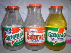 three bottles of gatorade sitting next to each other