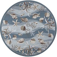 a blue rug with seashells on it