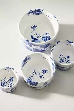 four blue and white porcelain bowls with the word soup on them