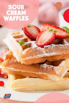 a stack of waffles topped with strawberries on top of a white plate