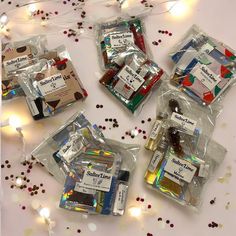 several packaged items sitting on top of a table covered in confetti and lights