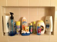 a shelf filled with lots of different types of toiletries on top of a tiled wall