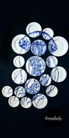 blue and white plates with designs on them in the shape of a man's head