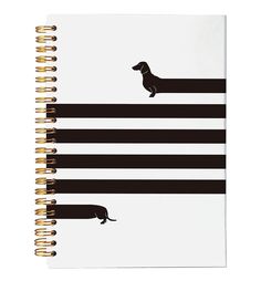 a spiral notebook with black and white stripes on the cover, featuring a dachshund