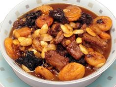 a white bowl filled with food on top of a table