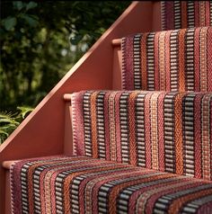 the stairs are lined with multicolored rugs on them, and there is no image here to provide a caption for