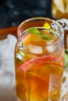 a pitcher filled with liquid sitting on top of a table