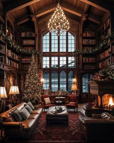 a living room filled with lots of furniture and a christmas tree in the middle of it