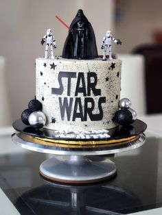 a star wars themed cake with black and white frosting