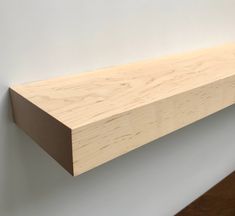 a wooden shelf mounted on the wall