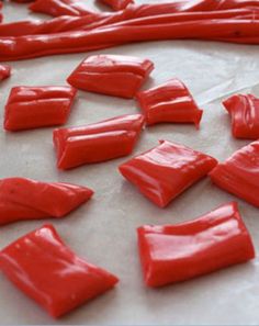 red icing is spread out on a sheet of white paper and ready to be baked