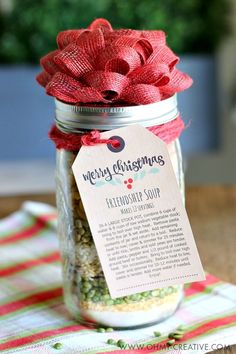 a jar filled with lots of different types of spices and seasoning next to a tag that says merry christmas