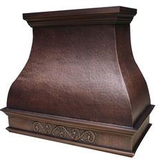 a brown leather range hood with ornate carvings on the front and sides, against a white background