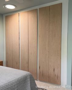 a bedroom with wooden closet doors and a bed