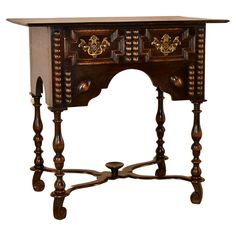 an old wooden table with ornate carvings on the top and bottom shelf, against a white background