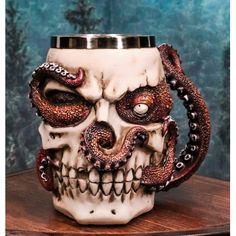 a skull mug with an octopus on it's face and tentacles around the mouth