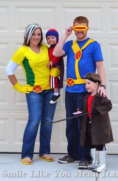 a family dressed up in costumes for the halloween season, standing next to a garage door