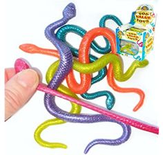 a hand is holding some colorful plastic snakes