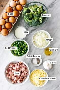 the ingredients to make broccoli salad laid out on a marble counter top with eggs, onions, cheese and milk