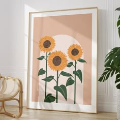 an art print with three sunflowers in front of a pink background and a wicker chair