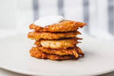 a stack of fried food sitting on top of a white plate