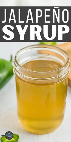 jalapeno syrup in a glass jar with green peppers around it and text overlay