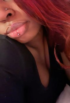 a woman with red hair sticking out her tongue