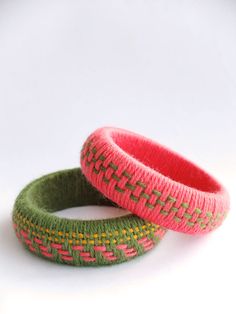 two knitted bracelets sitting next to each other