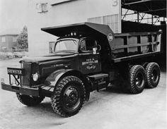 an old black and white photo of a dump truck