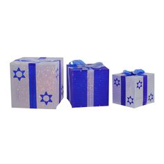 three blue and white gift boxes with bows on each one are wrapped in sequins