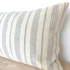 a striped pillow sitting on top of a wooden table