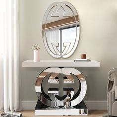 a living room with a round mirror on the wall and a white table in front of it