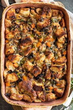 a casserole dish filled with stuffing and vegetables