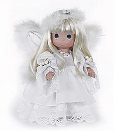 a doll dressed in white with angel wings