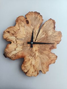 a clock made out of wood that looks like a leaf