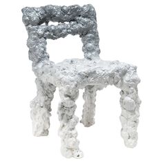 a white and gray chair sitting on top of a white floor