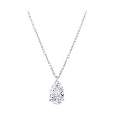 This exquisite pendant necklace features a stunning 4.22 carat pear cut diamond, gracefully suspended from a delicate 18K white gold chain. The diamond exhibits an E color grade, offering a near colorless brilliance that exudes sophistication. It's VS1 clarity ensures minimal inclusions, resulting in exceptional transparency and beauty. The excellent polish creates a flawlessly smooth surface that enhances the diamond’s radiant sparkle. With very good symmetry, the facets are precisely aligned, Luxury Oval Platinum Diamond Necklace, Luxury White Gold Teardrop Pendant Necklace, Pear Diamond Pendant, Expensive Jewelry Luxury, Pear Cut Diamond, Jewelry Luxury, Expensive Jewelry, Pear Diamond, Fine Jewels