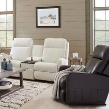 a living room with two recliners and a coffee table in front of the couch