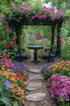 a garden filled with lots of flowers next to a stone path leading to a bench