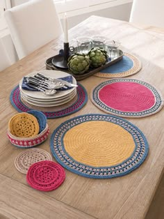 crocheted placemats and plates on a wooden table