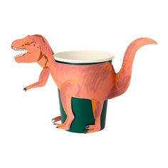 a toy dinosaur in a cup with its mouth open and it's tongue out