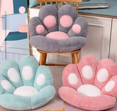 three chairs with paw prints on them sitting in front of a mirror and chair next to each other