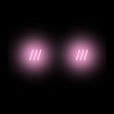 three pink lights in the dark on a black background