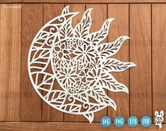 a paper cut out of the shape of a sun and moon on a wooden background