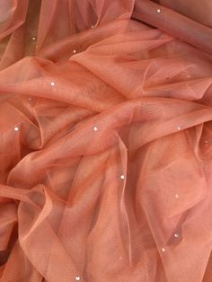 "Coral soft diamante tulle net fabric This is quality tulle studded fabric It is 45\" wide (114cm) This is ideal for bridal dresses,decorations,veil,under skirt, dance costumes and many other projects If more than one quantity is bought it will be sent in one continous length (Please note i try my best to get exact color of the fabric there might be a slight different in color due to different montior screens and camera lighting) Any questions feel free to ask and please take time to look at my shop" Tutu Decorations, Net Dresses, Skirt Dance, Coral Fabric, Bridal Decorations, Net Dress, Camera Lighting, Net Fabric, Coral Peach