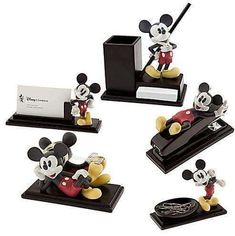 four mickey mouse figurines are on display