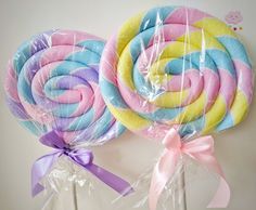 two lollipops wrapped in cellophane and tied with ribbon