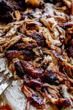 pulled pork with bbq sauce and cheese on a baking sheet, ready to be eaten