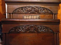 an antique wooden bed frame with intricate carvings